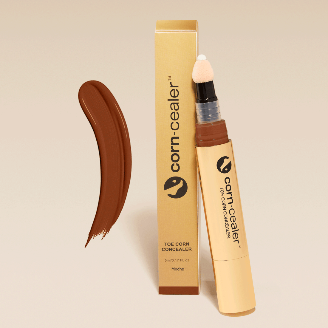 Toe Corn Concealer in Mocha shade with applicator and packaging. Provides flawless, water-resistant coverage for toe corns, perfect for open-toed shoes.