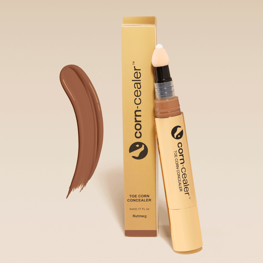 Toe Corn Concealer in Nutmeg shade with applicator and packaging. Instantly covers toe corns with flawless, water-resistant coverage for open-toed shoes.